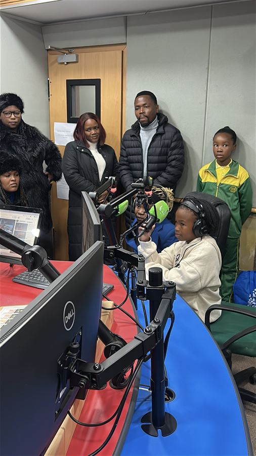 A young author speaking into the microphone in the EBIS Radio studio