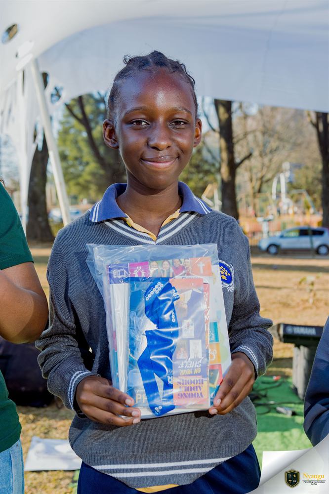 A young author smiling with the book hamper she won