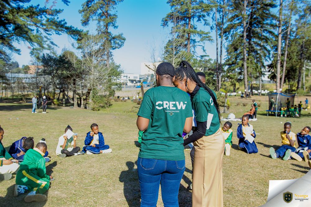 A Nyangu crew member leading a circle session with a group of children