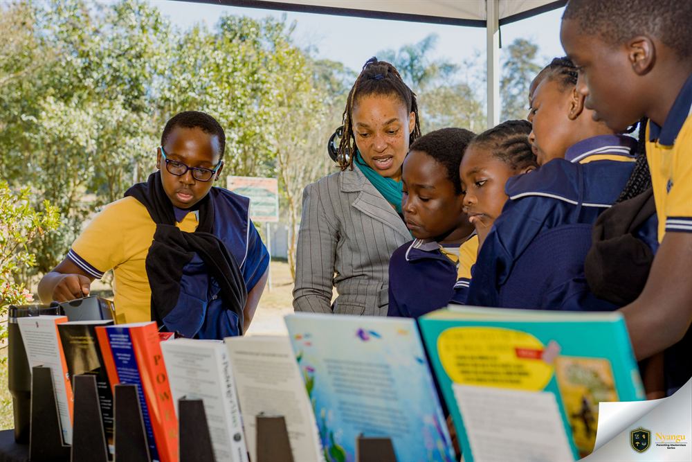 Children reading books together at one of the bookstore stands