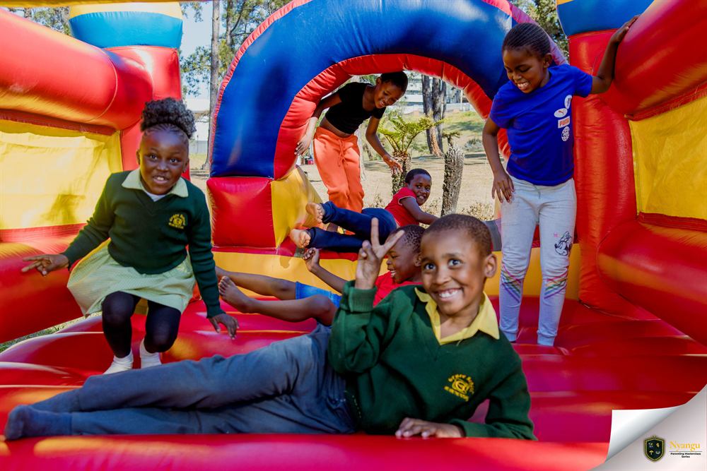 Children playing on the bouncy castle at the festival
